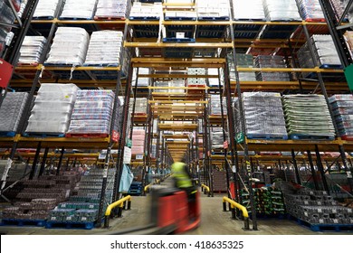 A forklift truck passing though a warehouse, motion blur