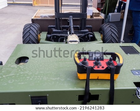 Forklift truck. Remote control for forklift. Loading equipment. Joystick to control forklift truck. Pulte with remote control function. Modern warehouse technology. Joystick for remote inspection