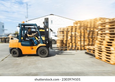 Forklift truck transports pallets of oil barrels in a warehouse - Powered by Shutterstock