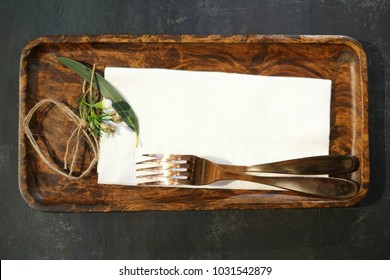 Forks on the wooden plate with vintage style decoration