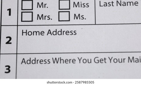 Form with Name and Address Fields. Paper form requests information like name, home address, and mailing address, with boxes for titles.