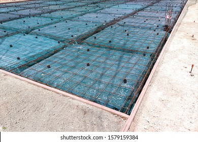 Form work and reinforcing placed over plastic sheeting in preparation for the concrete pour.This is a floating foundation also known as a balancing raft foundation. 