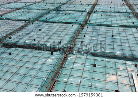 Form work and reinforcing placed over plastic sheeting in preparation for the concrete pour.This is a floating foundation also known as a balancing raft foundation. 