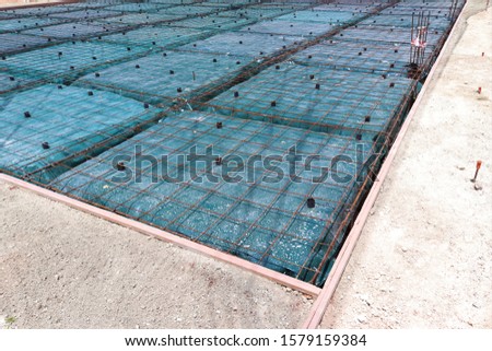 Form work and reinforcing placed over plastic sheeting in preparation for the concrete pour.This is a floating foundation also known as a balancing raft foundation. 