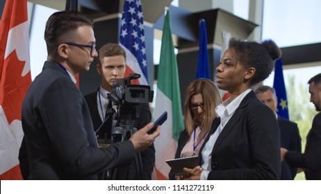 Formal African-American Woman Talking To Journalist For Camera And Giving Interview On International Summit