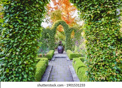 Formal gardens with clipped hedges, topiary and perennial flowers.