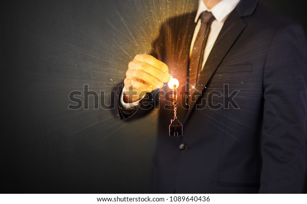 Formal man
hand over shiny keys with dark
background