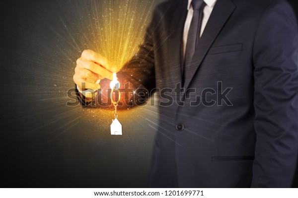 Formal man
hand over shiny keys with dark
background
