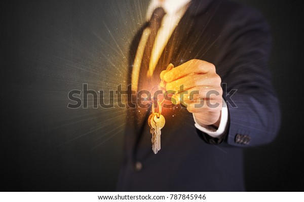 Formal
man hand over shiny keys with dark
background
