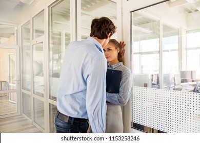 Formal Man And Woman Flirting While Standing In Hall Of Office Building Having Adultery