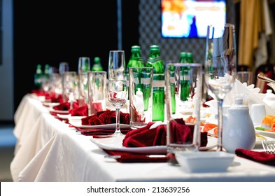 Formal Stylish Setting On A Dinner Table With Elegant Glassware And Red Linen For A Party Or Celebration Of A Special Event