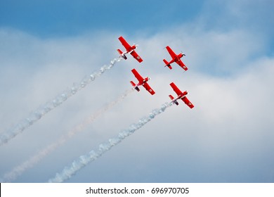 Formation of planes of the blue cloudy sky during the airshow.