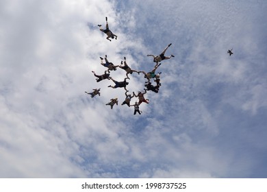 Formation Skydiving. Summeк. Skydivers In Shorts Fly In The Sky.
