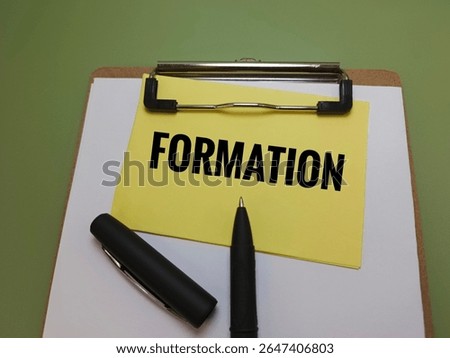 Formation Text on Yellow Note Clipped on Clipboard with Black Pen Representing Business Formation, Startup Planning, Company Establishment, Legal Registration, and Strategic Development Concept. 