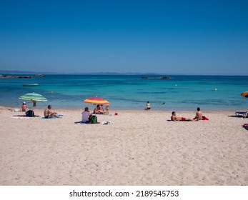 Formentera, Spain - May, 2010: People On The Beach With Umbrellas