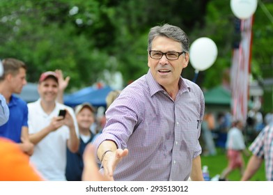 Former Texas Governor Rick Perry Greets A Voter At The Amherst, New Hampshire, July 4 Parade On July 4, 2015. 