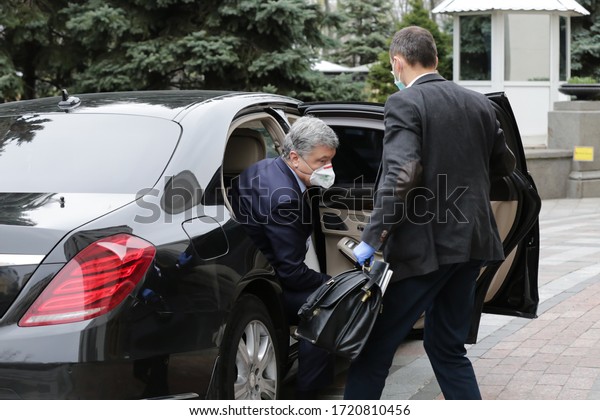 Former Ukrainian President and leader of European\
Solidarity political party Petro Poroshenko wearing a protective\
mask gets out of car near parliament building in Kyiv, Ukraine.\
March 30, 2020.