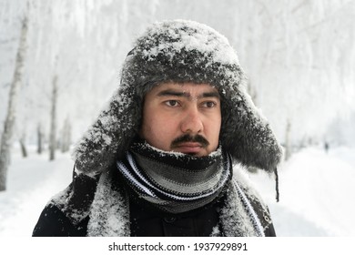 Formidable Russian Man In A Winter Hat And Scarf With A Stern Look