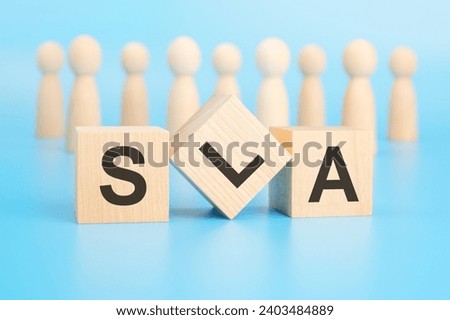 forming a conceptual word with blocks in the foreground - SLA (Service Level Agreement). the blocks are located on a blue surface in front of wooden figures symbolizing people.