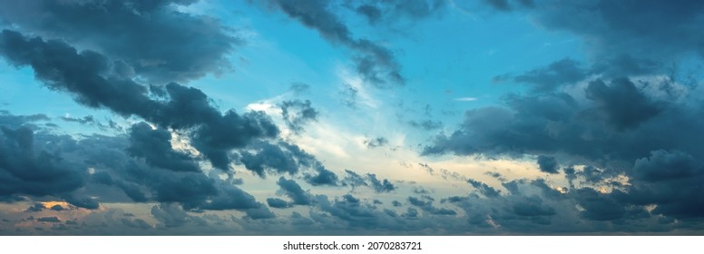 Formless Dark Clouds Blown By The Strong Wind At Evening. Scenic Dramatic Cloudscape At Blue Hour. Wide Overcast Panorama. The Weather Changes From Clear To Stormy. Windy Weather. Sky Only.