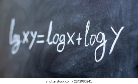 Formula with logarithms written on a blackboard with chalk