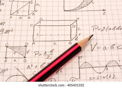 Formulas on the notebook. Sharp pencil on top of it