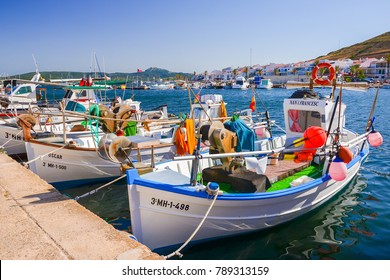 FORNELLS PORT, MINORCA ISLAND - JUN 17, 2017: Typical colorful fishing boats anchoring in Fornells port, Minorca island, Spain.