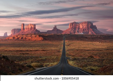 Forrest Gump Point, red rock at Monument Valley, Navajo Tribal Park, Arizona USA. Stunning view and scenic road in Utah during sunrise. Depth of long empty road.