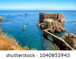 Fort São João Baptista of Berlengas, with anchored boats, seen from Berlenga island, with Peniche coast at sight. Portugal.