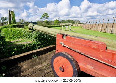 Fort Caroline National Memorial, Florida - 2021: Fort De La Caroline Reconstruction, An Attempted French Colonial Settlement On St. Johns River. Red Cannon. Timucuan Ecological Historic Preserve.