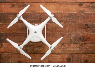 FORT COLLINS, CO, USA - DECEMBER 11, 2016:  DJI Phantom 4 pro quadcopter drone on a rustic wooden  table with a copy space.