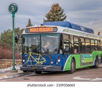 Fort Collins, CO, USA - January 18, 2022: Transfort Bus With A Female Driver, A Bike On Racks And Masks Required Banner At A Stop. Transfort Is A City Public Transportation Service.