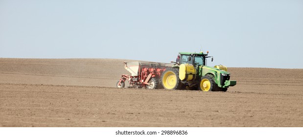 Fort Hall, Idaho, USA Apr. 17, 2015 A Tractor In The Field Planting Potatoes