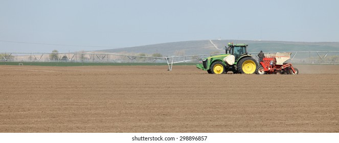 Fort Hall, Idaho, USA Apr. 17, 2015 A Tractor In The Field Planting Potatoes