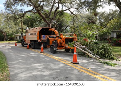 FORT LAUDERDALE, FL, USA:  Asplundh Tree Co. Chipper Truck Loaded With Palm Tree Trunks & Branches As They Clear Residential Electric Lines To Prepare For Hurricane Season As Seen On January 28, 2020.