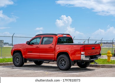 FORT LAUDERDALE, FL, USA - AUGUST 16, 2020: Photo of a red Toyota Tacoma in a parking lot