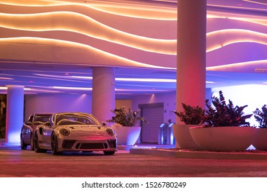 FORT LAUDERDALE, FL, USA - OCTOBER 2, 2019: Porsche GT3RS Parked At A Hotel Valet Ramp Colorful Bright Neon