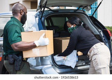 Fort Lauderdale, Florida, USA - February 27, 2021: Broward Sheriff's Office BSO and Feeding South Florida are contributing the collaboration mission of fighting hunger in South Florida. Drive-thru.