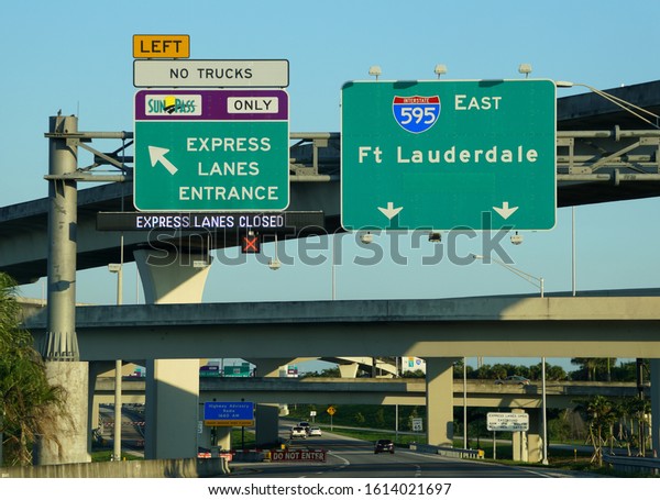 Fort Lauderdale, Florida, U.S.A - January 3,\
2020 - The view of the road signs into Interstate 595 East and\
Sunpass Express Lane\
entrance