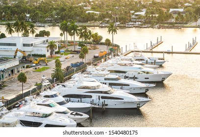 Fort Lauderdale, Florida, USA - September 19, 2019: Luxury yacht parked on a canal with the sun coming down at Fort Lauderdale. Port of Fort Lauderdale with Sunset at the marina area