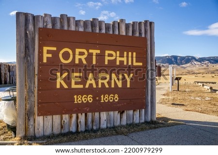 Fort Phil Kearny State Historic Site log post entrance sign written in yellow letters.