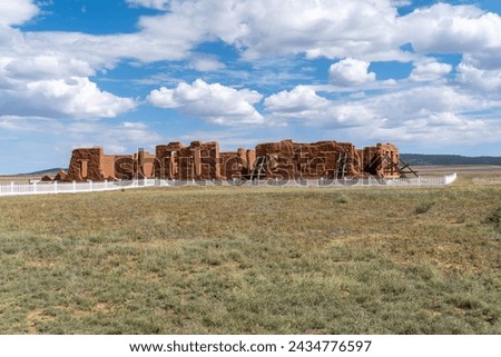Fort Union National Monument in New Mexico. Preserves fort's adobe ruins along Santa Fe Trail. Hospital remnants with white fence. Post surgeons cared for the health of soldiers and civilians. 