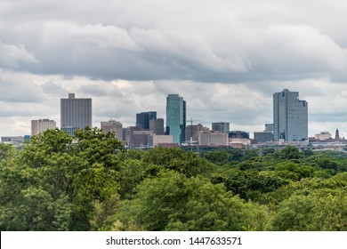 Fort Worth City In Texas With Green Trees In Park And Cityscape Skyline And Cloudy Day