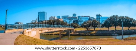 Fort Worth panoramic city skyline and building architecture over Trinity River in Texas, USA, modern cityscape with natural open space and trails