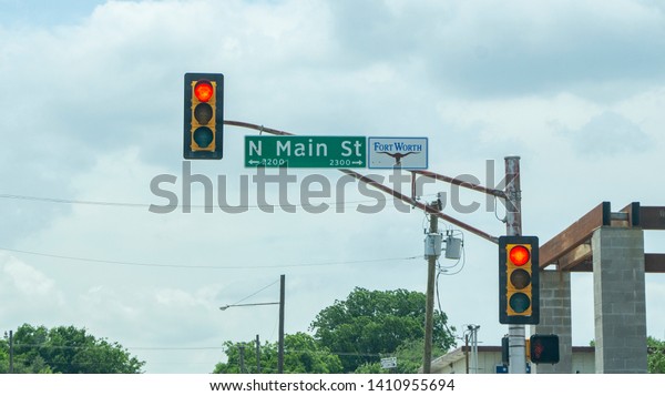 Fort Worth, Texas - MAY 20,\
2019:\
\
North Main Street road sign, with red traffic\
lights.