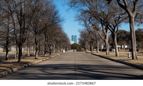 Fort Worth, Texas, United States - December 25, 2020: Picture Of The Omni Hotel At The Very End Of A Road Lined By Trees.