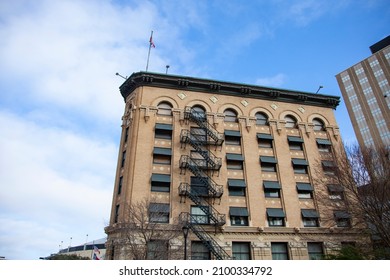 Fort Worth, Texas - USA - January 1, 2022 - An Historic Apartment Building In Downtown With A Fire Escape Is Seen On A Sunny Winter Day With A Blue Sky.