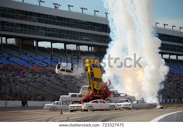 Fort Worth, Texas,\
USA - June 7th 2013 - Izod Indycar Series Texas Motor Speedway -\
Stunt car driver Spanky Spangler Jr crashes through an 8 car\
pyramid before the Firestone\
550.