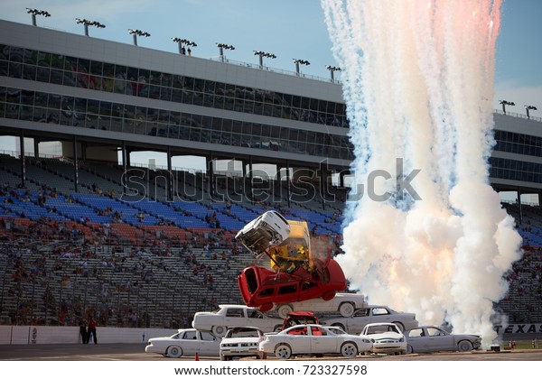 Fort Worth, Texas,\
USA - June 7th 2013 - Izod Indycar Series Texas Motor Speedway -\
Stunt car driver Spanky Spangler Jr crashes through an 8 car\
pyramid before the Firestone\
550.