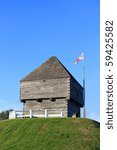 Forth Howe, the site of an 18th and 19th century British Army fortification on a hill in Saint John, New Brunswick, Canada surrounded by blue sky with waving flag